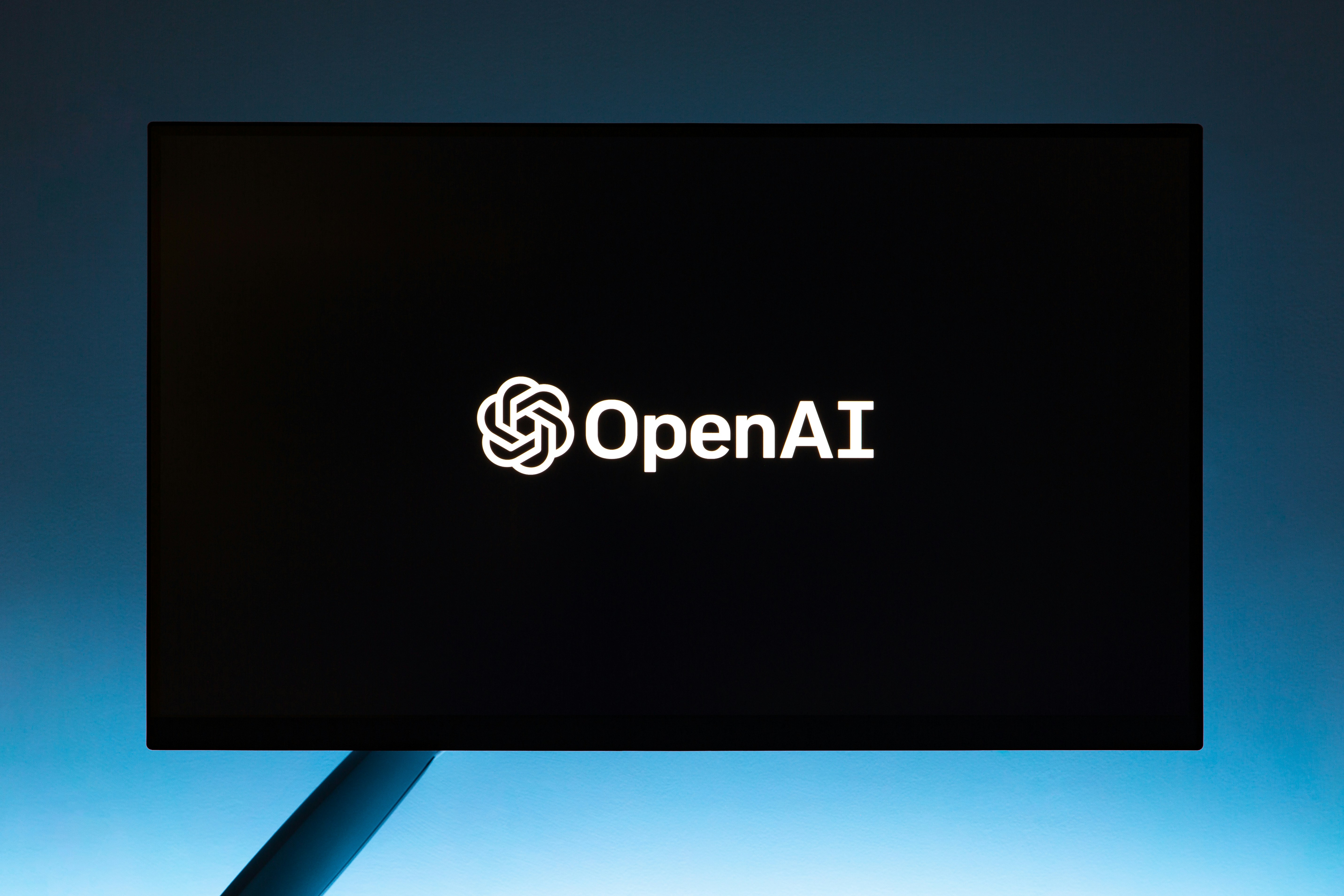 Person browsing ChatGPT on a laptop exploring AI advertising options