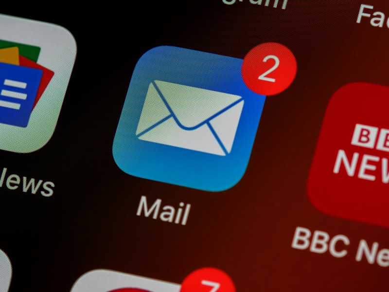 Email app icon with new message notifications on a phone screen