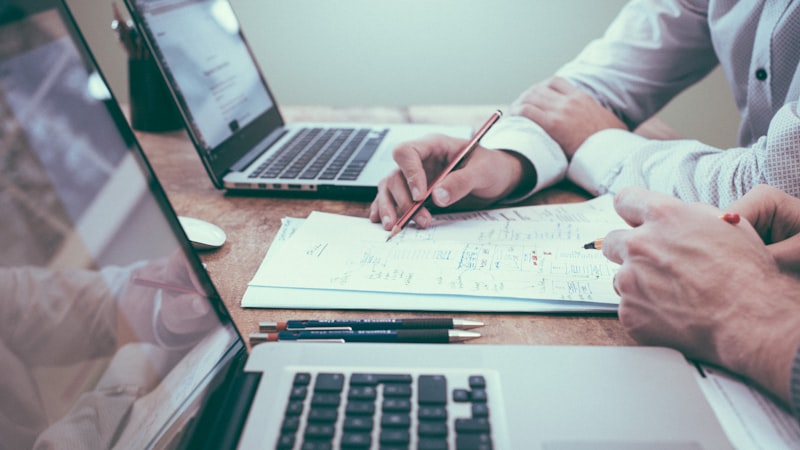 Person writing and planning content strategy at a desk